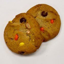 Two Reese's pieces cookies on a white background