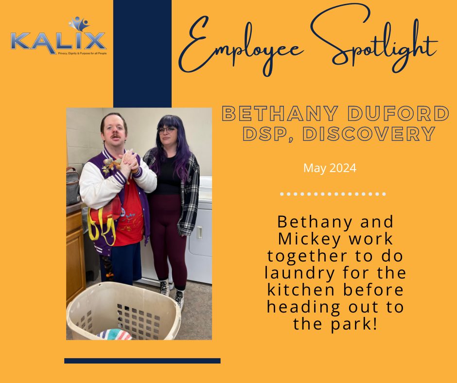 Employee Spotlight - Bethany Duford, DSP Discovery. May 2024. Bethany and Mickey work together to do laundry for the kitchen before heading out to the park! Photo on left shows Mickey standing in a purple and white jacket smiling and holding his hands together in front of a laundry basket. To his right, Bethanhy stands in a black and white flannel jacket, black shirt and maroon pants. 